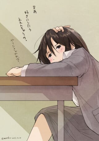 机に突っ伏して頬杖をつくマキタ