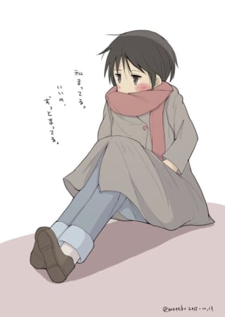 マキタが地面に座り、スカーフを巻いて待ち続けている