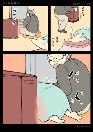 こたつでくつろぐ猫と男性